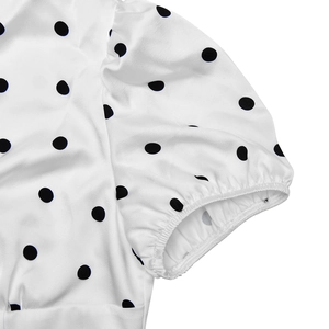 Close-up of French style polka dot dress featuring elastic bubble sleeves and fabric detail