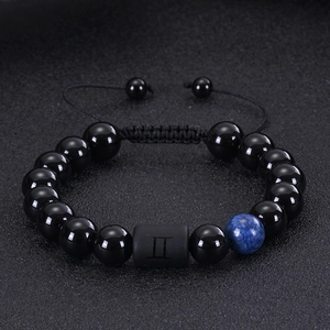 Detail of adjustable beaded bracelet with black onyx and Gemini zodiac sign bead