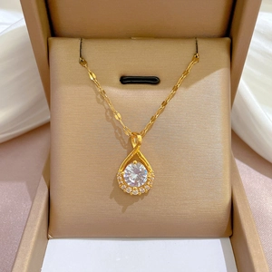 Macro view of water-drop pendant necklace with sparkling gems in a jewelry box