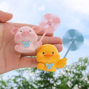 Cartoon pig and duck car air vent fragrance clips with spinning windmills outdoors