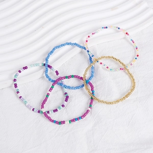 Detail of bohemian colorful bead bracelet set with mixed glass beads and elastic cord