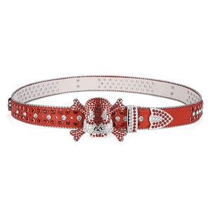 Close-up of red crocodile texture belt featuring rhinestone skull buckle and sparkling crystals