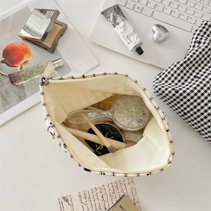 Trousse à maquillage à carreaux montrant l'espace intérieur pour produits de beauté