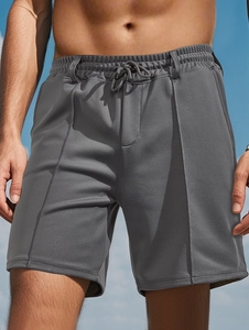 Close-up of men's dark grey quick-dry mesh shorts featuring an adjustable drawstring waist