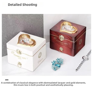Detail view of heart-shaped music boxes in white and mahogany finish with metal locks