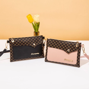Retro geometric printed crossbody bags with gold studs and brand logo in soft lighting