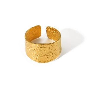 Macro shot of 18k gold plated stainless steel ring with hammered metal texture detail