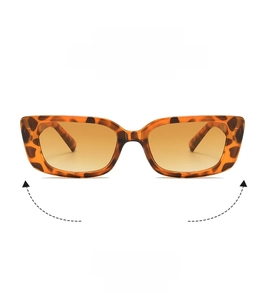 Close-up of retro tortoiseshell sunglasses with brown gradient lenses and slim frames