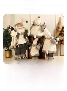 Detailed view of plush Santa figures in soft grey and cream tones for modern Christmas decor
