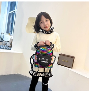 Detail of colorful sequined kids backpack featuring heart patch and holographic wings