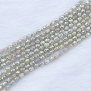 Close-up of 4x5mm strawberry drop faceted beads with iridescent silver-grey finish