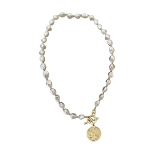 Vintage pearl necklace with golden portrait coin pendant and OT buckle on white base