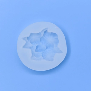 Round silicone flower mold for DIY baking and handmade crafts on a blue background