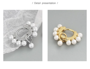 Detail view of S925 sterling silver hoop earrings with white pearls and sparkling zircons