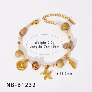 Detail of gold starfish and shell charms on beach-style bracelet with resin beads