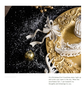 Detailed view of white glitter bows and golden ornaments on a festive black background