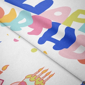 Close-up of soft velvet fabric showing colorful Happy Birthday print and texture