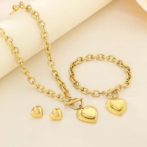 Detailed view of golden stainless steel heart jewelry set with necklace and bracelet