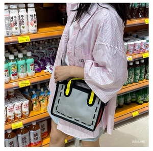 Detail of 2D comic style canvas tote bag with yellow handles and unique flat visual design