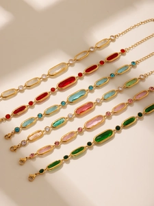 Detail of elegant gold-plated bracelets featuring vibrant colorful Czech glass stones