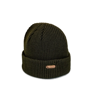Detailed macro view of the olive green ribbed knit beanie with a leather reindeer tag