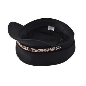 Top view of a black baker boy hat featuring a stylish leopard print chain band detail