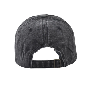 Detail of washed cotton baseball cap showing adjustable metal buckle and seam stitching