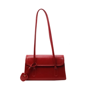 Glossy red faux leather shoulder bag for women with a heart pendant and slim strap