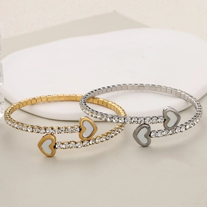 Luxurious gold and silver heart bracelets with crystals and shell inlay in macro view