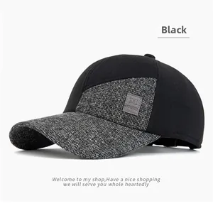 Detail of men's winter baseball cap showing black grey contrast and leather logo patch