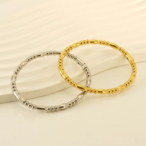 Minimalist 18k gold and silver stainless steel bamboo style bangles on elegant wavy base