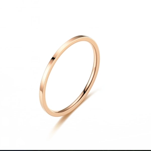 Detail of slim rose gold titanium steel ring with smooth polished minimalist surface