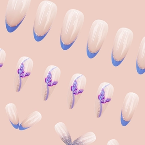 Almond press-on nails featuring blue French tips, purple butterfly art and silver glitter