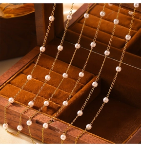 Detailed view of pearl station necklace on a premium velvet jewelry display box