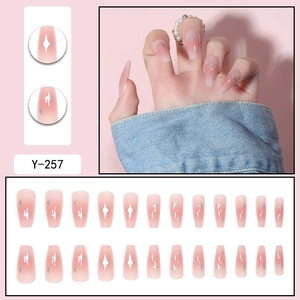Pink gradient press-on nails with silver star patterns in 24-piece full set kit