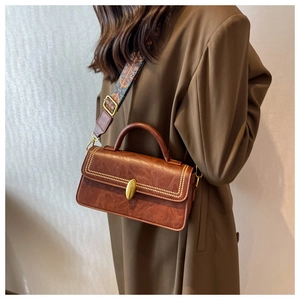 Retro dark brown crossbody bag with gold studs and ethnic jacquard woven strap detail