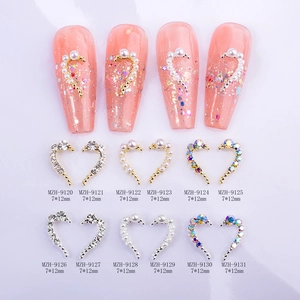 Symmetric heart shaped nail charms with crystals and pearls in gold and silver plating
