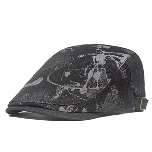 Detailed side view of black jacquard newsboy cap with abstract pattern and metal buckle