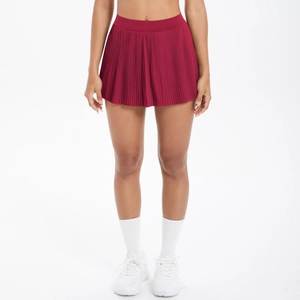 Détail de la jupe de tennis plissée rouge montrant la taille haute et le tissu sport