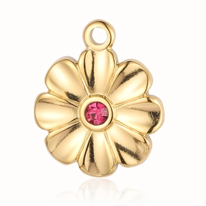 Close-up of golden flower pendant with pink gemstone and polished finish on white background
