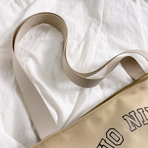 Minimalist canvas tote bag in khaki with reinforced shoulder strap stitching detail