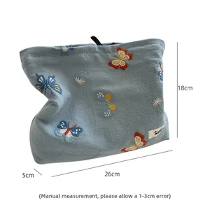 Detail view of embroidered butterfly makeup bag with specific dimensions 26x18x5 cm