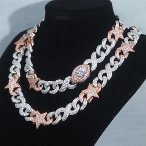 Close-up of hip hop cuban chains with star and eye pendants in silver and rose gold