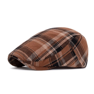 Detailed side view of vintage plaid newsboy cap featuring brown and beige cotton fabric