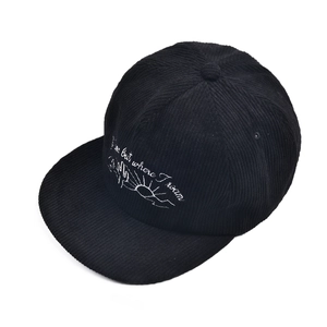 Detailed white cactus embroidery and text on black corduroy flat brim baseball cap