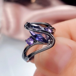 Marquise cut purple zircon ring in black plated metal with a fluid aesthetic design