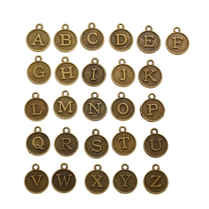 26 round bronze alloy A-Z alphabet charms for DIY jewelry making on white background