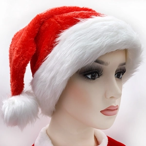 Classic red and white plush Christmas hat with pom-pom on female mannequin head