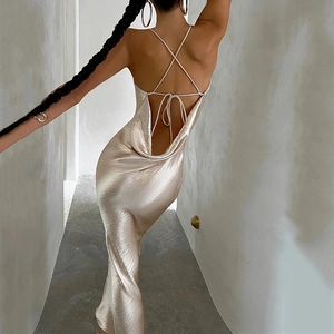 Detail showing cross-back thin strap design on a champagne silk backless maxi dress