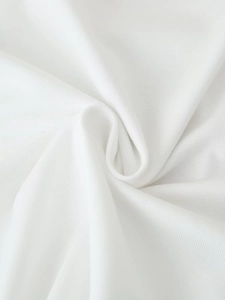 Close-up of soft white knitted fabric texture showing fine weave and natural folds
